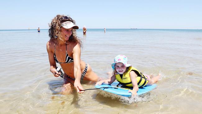 Ish Baxter and daughter Chloe, 3, cool off at Port Melbourne. Picture: Aaron Francis