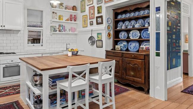 The kitchen at 20 Faversham Street, Woolloongabba contains European appliances and Carrara marble countertops with an American oak kitchen island.