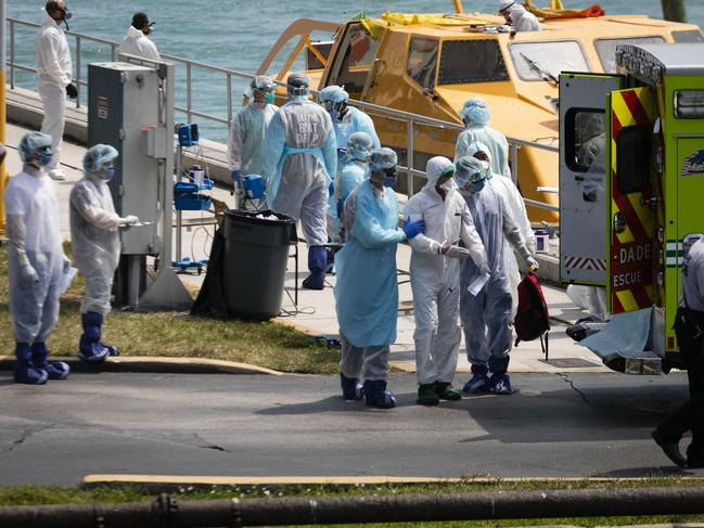 Medical staff transfer suspected Coronovirus patients in an ambulance to a medical facility after they arrive at the United States Coast Guard Base in Miami Beach.