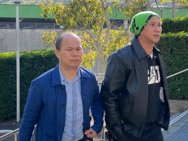 Eric Phu Soksan, 46, of Terrigal, (left) arriving at Gosford Court with his oldest brother Khuon Phu (right) who gave evidence at his appeal. Picture: Richard Noone