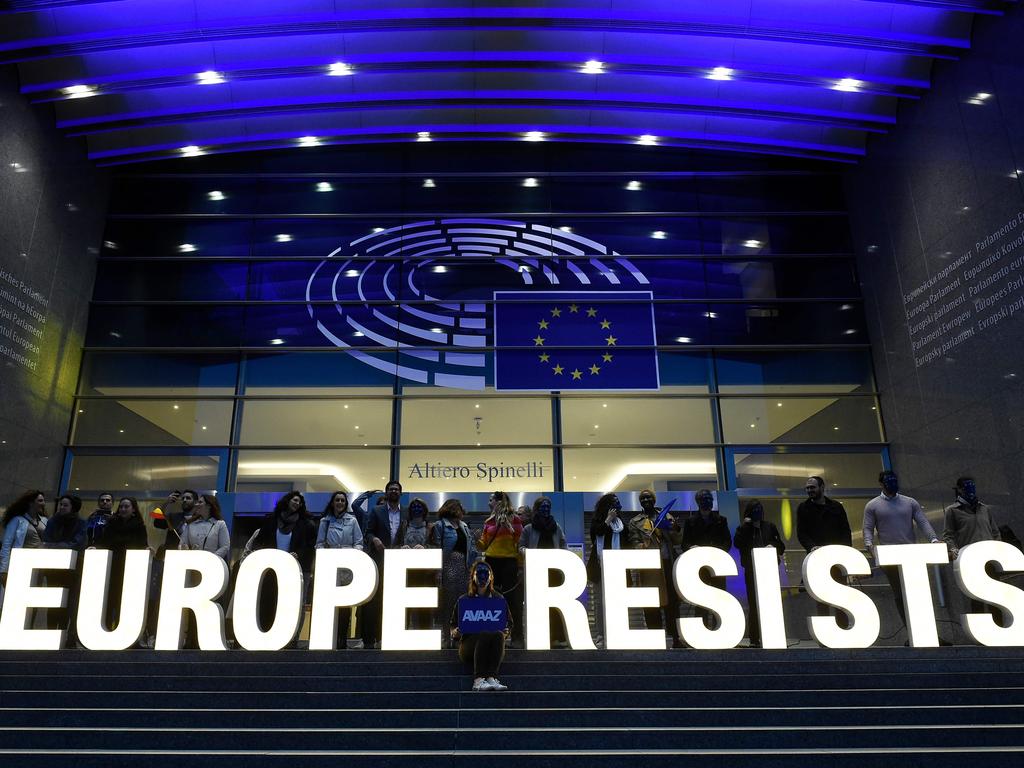 Activists from Avaaz hold a sign outside the EU Parliament as results roll in. Greens, liberals and populist parties have shaken up the balance of power. Picture: John Thys/AFP.
