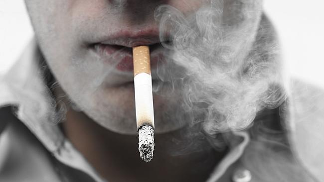 Close-up of mouth with cigarette between lips, smoking.