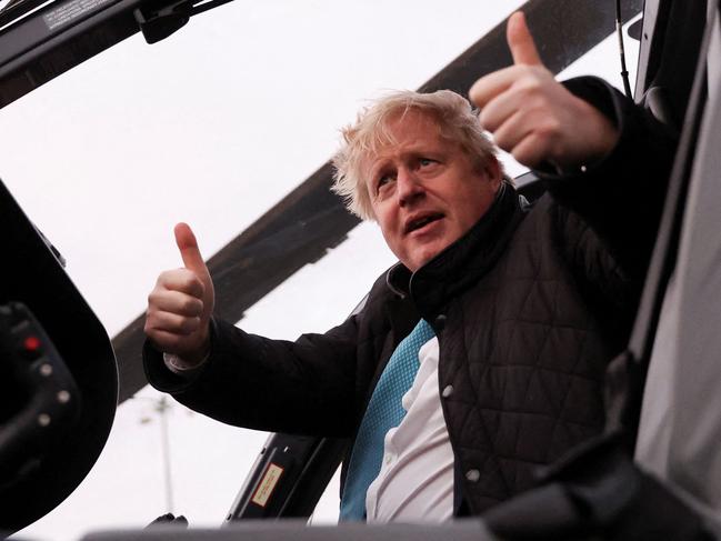 TOPSHOT - Britain's Prime Minister Boris Johnson gestures during a visit to RAF Valley, the Royal Air Force station on the island of Anglesey in north Wales on January 27, 2022. - Boris Johnson on Thursday awaited a report into lockdown-breaking parties at Downing Street that could determine his future as Britain's prime minister, and rejected new claims that he prioritised pets over people in the chaotic Afghan evacuation. (Photo by CARL RECINE / POOL / AFP)