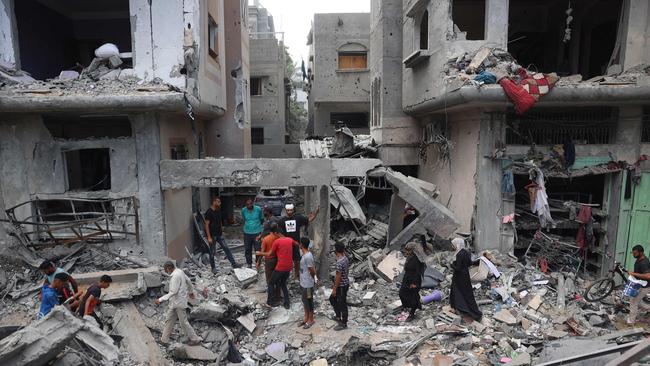 Palestinians inspect the damage and debris a day after the rescue operation by the Israeli Special Forces in the Nuseirat camp. Picture: AFP.