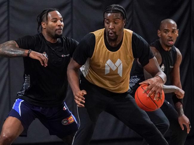 Jordan Caroline and Xavier Rathan-Mayes meet the might of Ariel Hukporti. Picture: Melbourne United Media