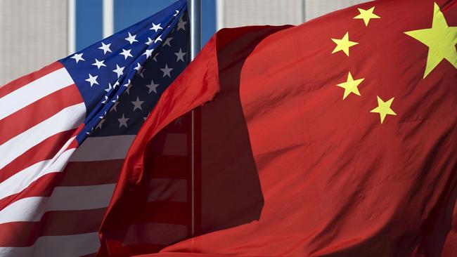 05/09/2012 WIRE: U.S. flag and China's flag flutter in winds at a hotel in Beijing Wednesday, Sept. 5, 2012. U.S. Secretary of State Hillary Rodham Clinton is in Beijing to press Chinese authorities to agree to peacefully resolve disputes with their smaller neighbors over competing territorial claims in the South China Sea. But as she began her meetings here, China questioned the stated neutrality of the United States. (AP Photo/Andy Wong) Pic. Ap