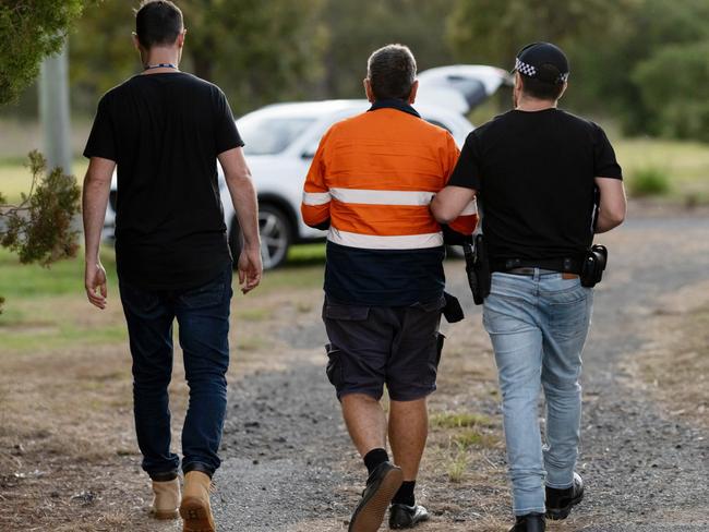 A man is arrested by police. Picture: AFP