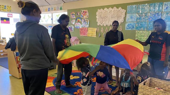 Willowra early child hood centre - Families and caregivers engage in learning games with the children. Picture: Supplied/ Central Land Council