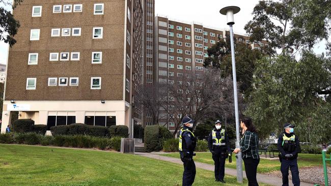 Police stand guard at one of nine public housing estates locked down due to a spike in COVID-19. Picture: AFP