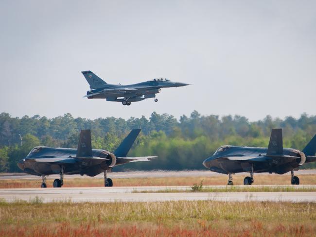 Testing times ... Two F-35s prepare for takeoff as an F-16 lifts into the air. Source: USAF