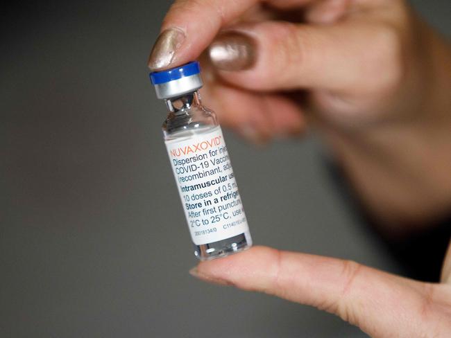 A woman holds a vial with the "Nuvaxovid" vaccine against the COVID-19 in Hagenbrunn, Lower Austria. Picture: AFP.