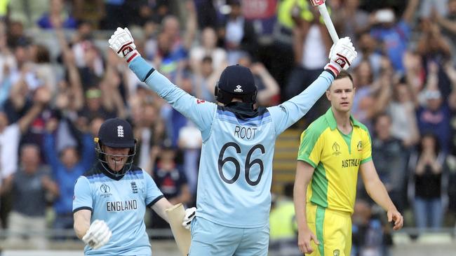 England captain Eoin Morgan (left) and Joe Root (centre) celebrate their World Cup semi-final victory as Australian paceman Jason Behrendorff looks on. Picture: AP