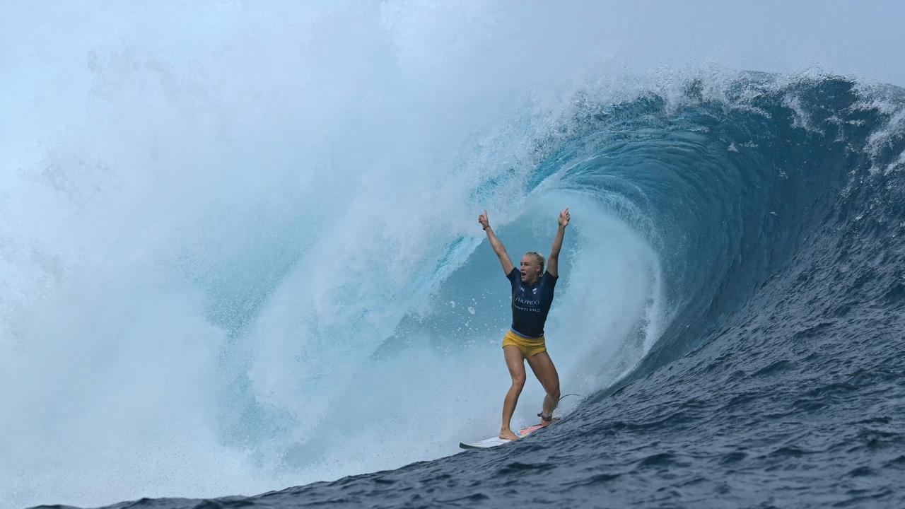 Brazilian surfer Tatiana Weston-Webb reacts after catching a big wave while competing in the semifinals in the Shiseido Tahiti Pro surfing competition in Teahupo'o, on the French Polynesian Island of Tahiti, on May 29, 2024. Teahupo'o will host the surfing event of the Paris 2024 Olympic Games. (Photo by JEROME BROUILLET / AFP)
