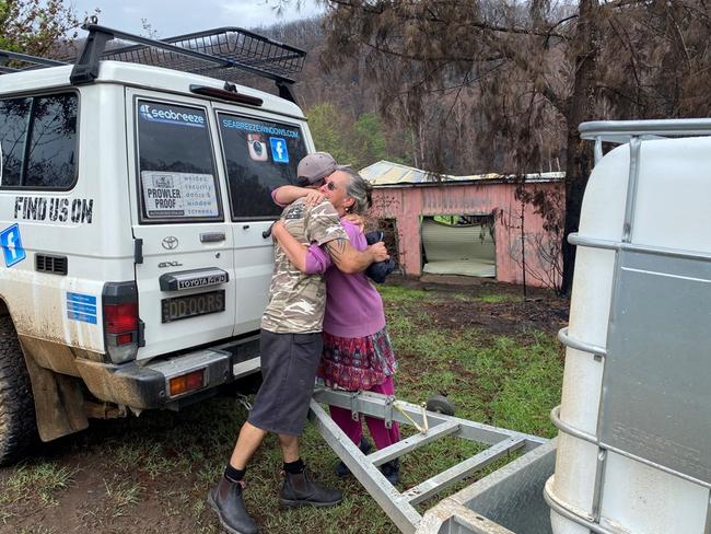 A happy recipient of a donated household water tank at a property near Mogo. Picture: Carl Hinton