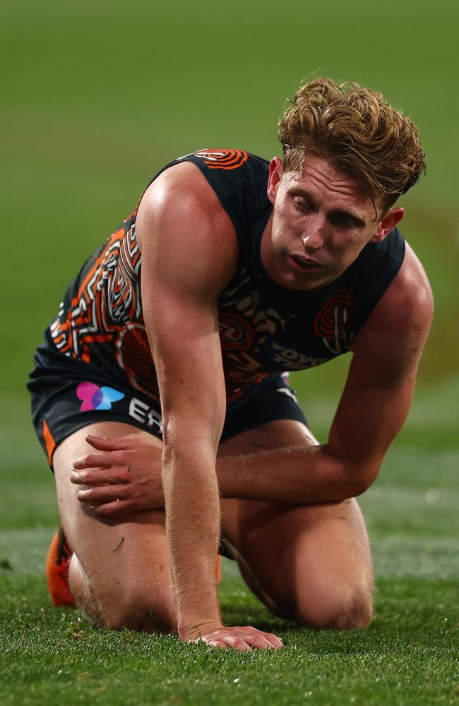 Lachie Whitfield grimaces after being crunched. Picture: Graham Denholm/Getty Images