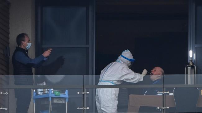 WHO team member Peter Daszak gives a swab sample to test for COVID-19 in Wuhan. Picture: AFP