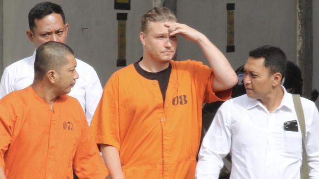 David Van Iersel is escorted by police for interrogation. Picture: Lukman S. Bintoro