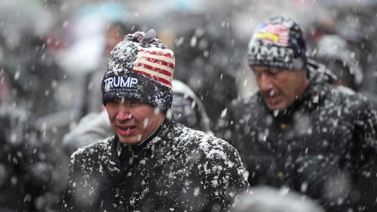 People queue in the snow at Capital One Arena for Donald Trump's victory rally on January 19, 2025 in Washington, DC. (Photo by Christopher Furlong / GETTY IMAGES NORTH AMERICA / Getty Images via AFP)