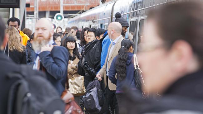 Commuters crowd the platform at North Melbourne Station. Picture: Nathan Dyer