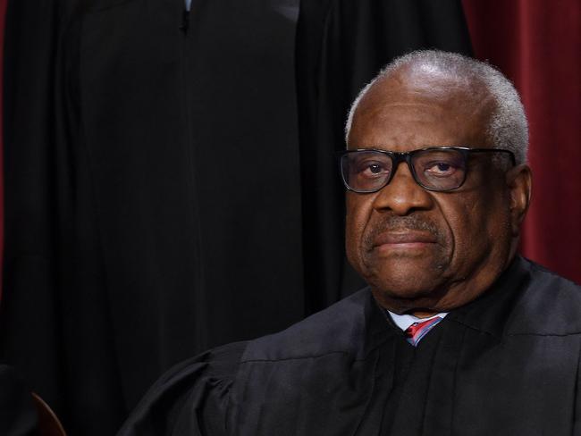 (FILES) In this file photo taken on October 7, 2022 associate US Supreme Court Justice Clarence Thomas poses for the official photo at the Supreme Court in Washington, DC. - A billionaire Republican donor paid for the private school tuition of Justice Clarence Thomas's grandnephew, whom he was raising at the time, a report said on May 4, 2023 -- the latest in a string of ethics controversies surrounding the US Supreme Court. Thomas did not disclose the payments, according to ProPublica, which also reported last month that conservative real estate tycoon Harlan Crow had gifted the longest-serving justice luxury trips over two decades. (Photo by OLIVIER DOULIERY / AFP)