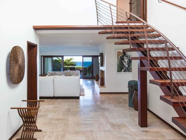 An open staircase leads up to the bedrooms above.