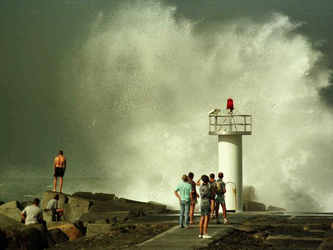 1998: A big wave crashes onto the end of the seawall at Main Beach.