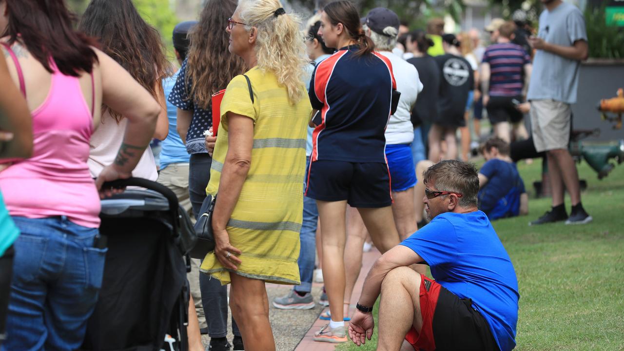 Lines of people wait at Southport Centrelink. Picture: Adam Head.