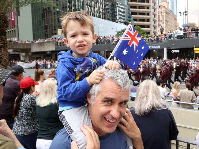 Davide Pizzocaro, 43, of Hawthorn with son Luca, 2, at the ANZAC day march, Brisbane. Picture: Liam Kidston
