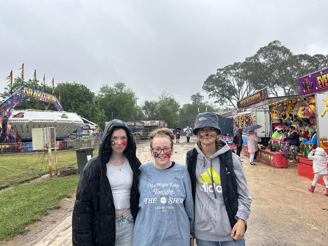 Bree Williams, Abbey Richards and Amanda Ward braved the rain on Friday at the Benalla Show.