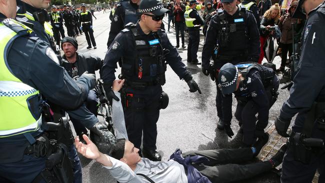 Police cart off Exctinction Rebellion protesters in Melbourne’s CBD. Picture: David Crosling