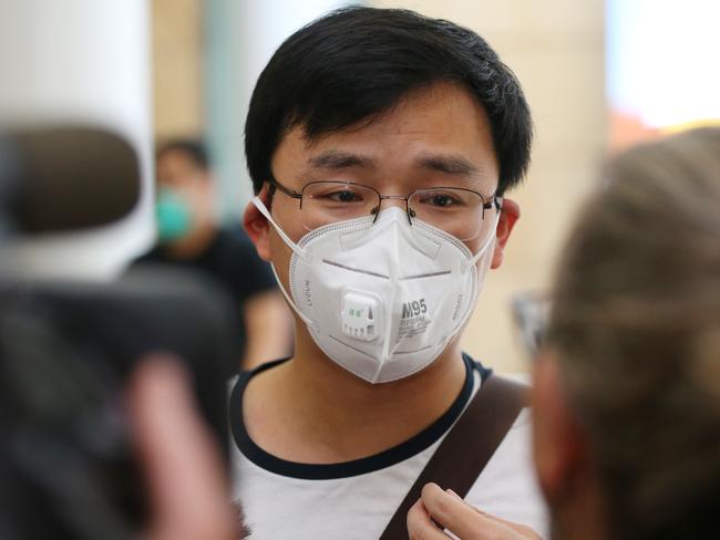 Kevin Ouyang being interviewed by the media after arriving at Sydney International Airport. Picture: Don Arnold/Getty