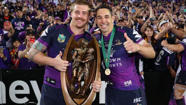 Storm stars Cameron Munster and Billy Slater with the Provan-Summons Trophy after winning the North Queensland Cowboys in the 2017 NRL Grand Final. Picture: Getty Images