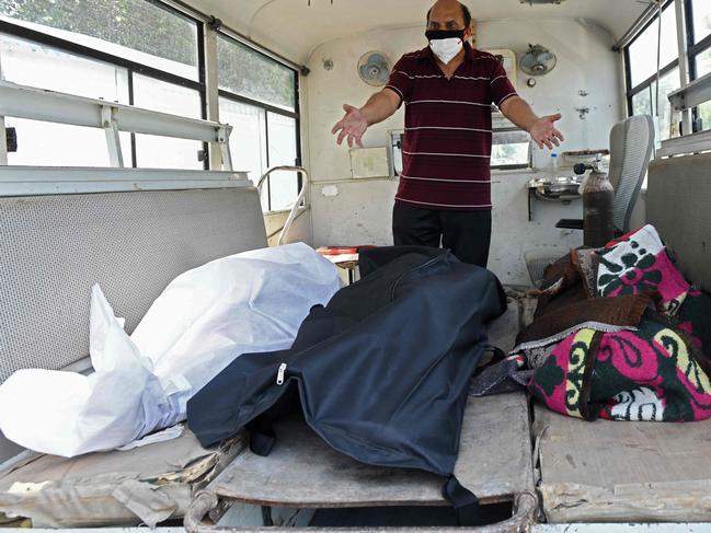 An Indian man reacts to the bodies of relatives dead from coronavirus. Picture: AFP