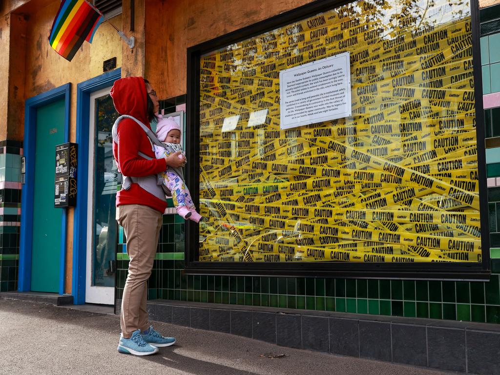 Shyan Fang, from Redfern, with her 5-month-old daughter, outside The Bearded Tit on Friday after it was forced to remove the explicit images on display in its front window. Picture: Justin Lloyd