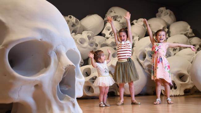 Ayleh, Mena and Larah check out Mass, an installation of 100 larger-than-life skulls at NGV Triennial. Picture: Josie Hayden