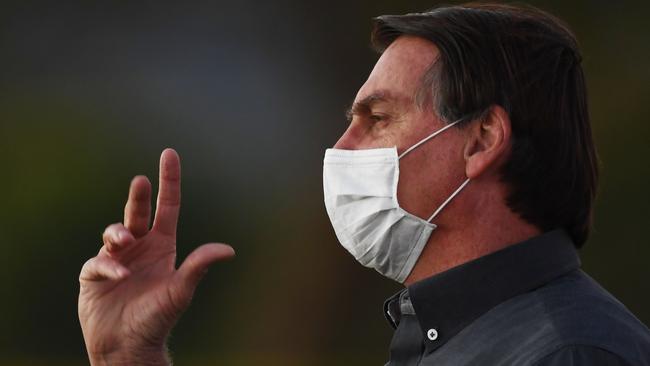 Brazilian President Jair Bolsonaro waves to supporters from the Alvorada Palace. Picture: AFP.