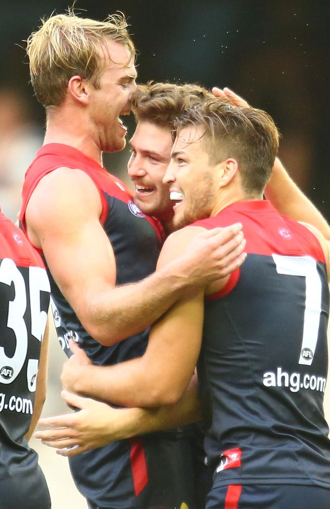 Melbourne teammates Jack Watts, Tomas Bugg and Jack Viney celebrate a goal during the NAB Challenge. Picture: Getty Images