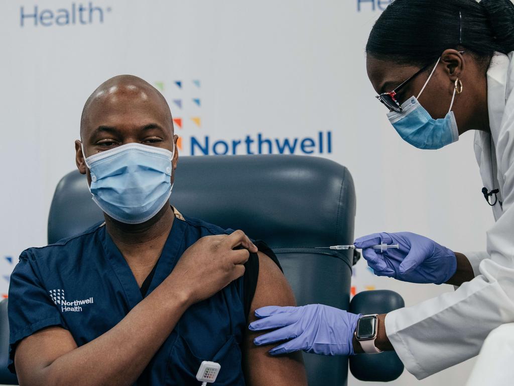 Lenox Hill Hospital Chair of Emergency Medicine, Dr Yves Duroseau, receives the COVID-19 vaccine from Dr Michelle Chester at Long Island Jewish Medical Center, New York, on December 14, 2020. Picture: Scott Heins/Getty Images/AFP