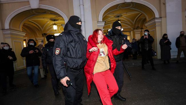 Russian police detain a woman during a protest against the invasion of Ukraine.