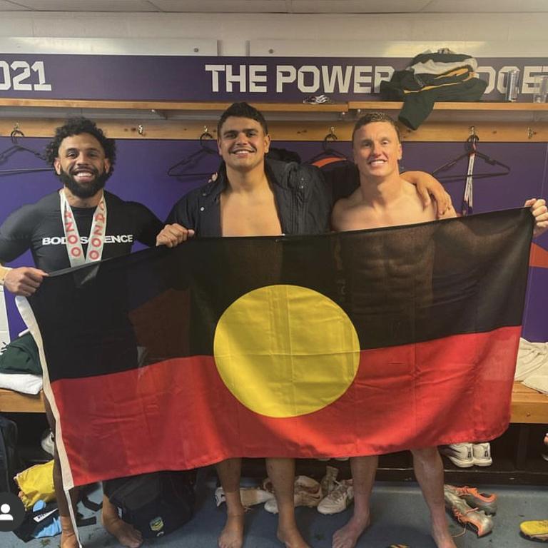 Josh Addo-Carr, Latrell Mitchell and Jack Wighton hold up the Australian Aboriginal flag while representing the Kangaroos during the Rugby League World Cup. Credit: Instagram.