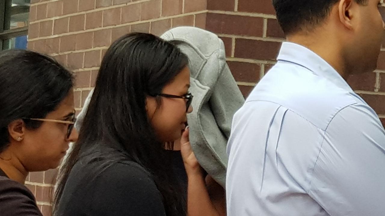 Tina Pham, centre, dressed in a black shirt and wearing glasses with her long dark hair out, enters Burwood Local Court followed by her lawyer Cheryl Khurana before pleading guilty to smuggling 394 MDMA capsules internally to a music festival. Picture: Candace Sutton/news.com.au