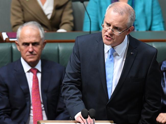 Federal Treasurer Scott Morrison hands down his third Federal Budget with Prime Minister Malcolm Turnbull watching on. Picture: AAP Image/Dean Lewins