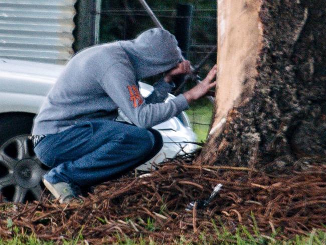 Brother of Dale Wilson, Matt Wilson sits at the crash site on Williss Drive in Normanville, Tuesday, July 30, 2019. (AAP Image/ Morgan Sette)