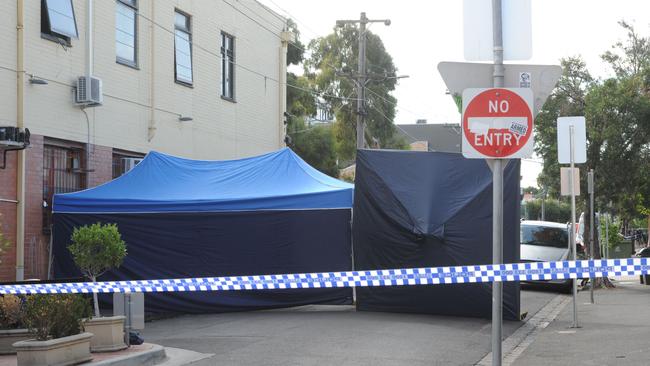 Police officers investigating the circumstances surrounding the death of a man in Brunswick East. Police were called to St Phillip Street around 3am where the man's body was located on the footpath in Melbourne, Tuesday, March. 15, 2016. (AAP Image/Mal Fairclough) NO ARCHIVING