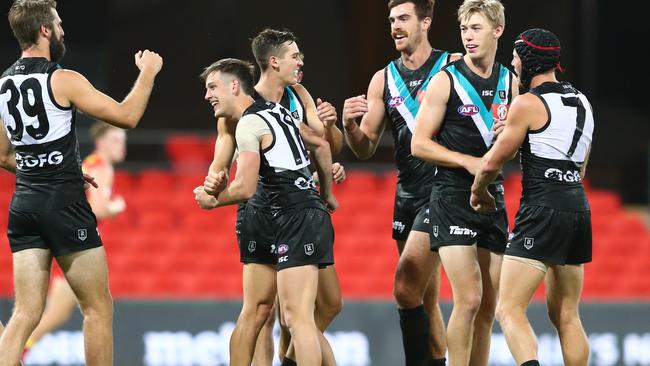 Zak Butters celebrates with teammates in round one. Picture: Chris Hyde/Getty Images.