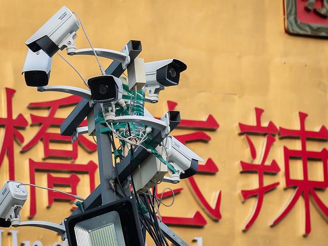 Security cameras overlook the entrance to a bar and restaurant area in Beijing on April 20, 2020. Picture: AFP