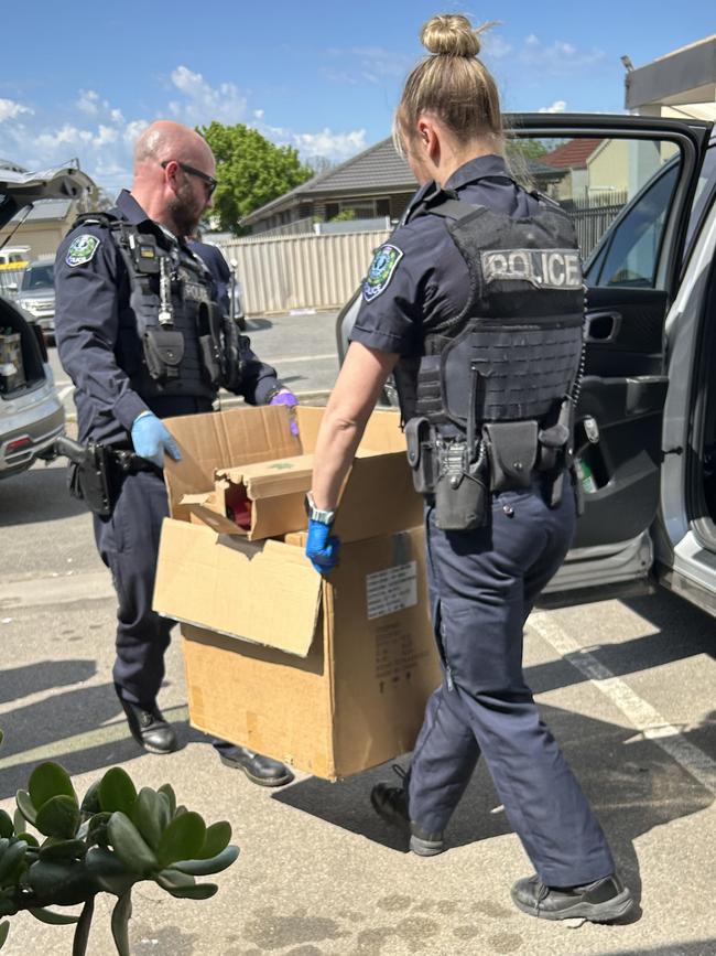 Police seizing allegedly illegal merchandise from the Rosewater tobacco store it was hit by an attempted arson attack overnight. Picture: Natalie Vikhrov