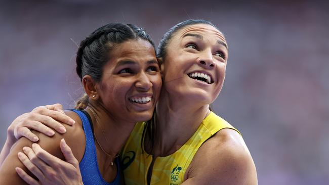 Michelle Jenneke (right) all smiles embracing Jyothi Yarraji of India after the women's 100m hurdles repechage in Paris. (Photo by Hannah Peters/Getty Images)