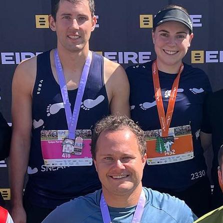 Mitchell Gaffney and Maddy Edsell with the MC of their wedding Alex Tigani after they participated in a half marathon in March.