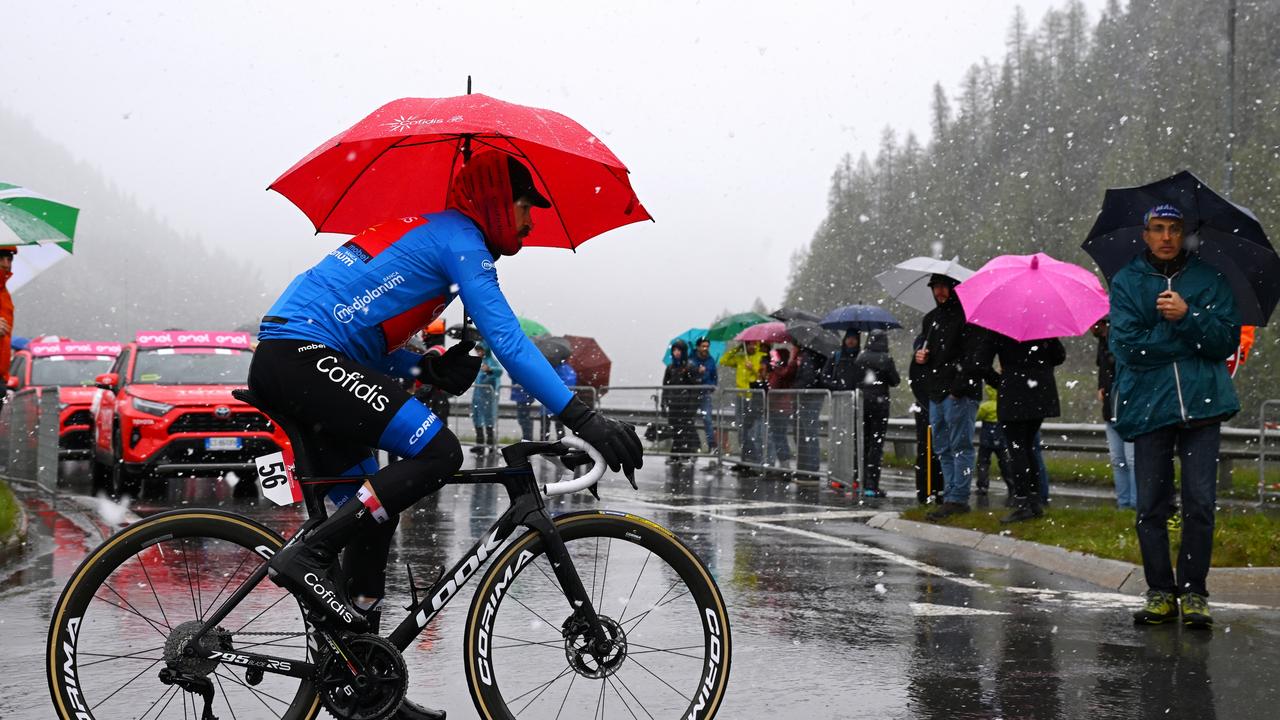 LIVIGNO, ITALY - MAY 21: Simon Geschke of Germany and Team Cofidis - Blue Mountain Jersey in the rain and snow prior to the 107th Giro d'Italia 2024, Stage 16 a 206km stage from Prato di Stelvio to Santa Cristina Valgardena - Monte Pana 1625m / #UCIWT / on May 21, 2024 in Livigno, Italy. (Photo by Tim de Waele/Getty Images)